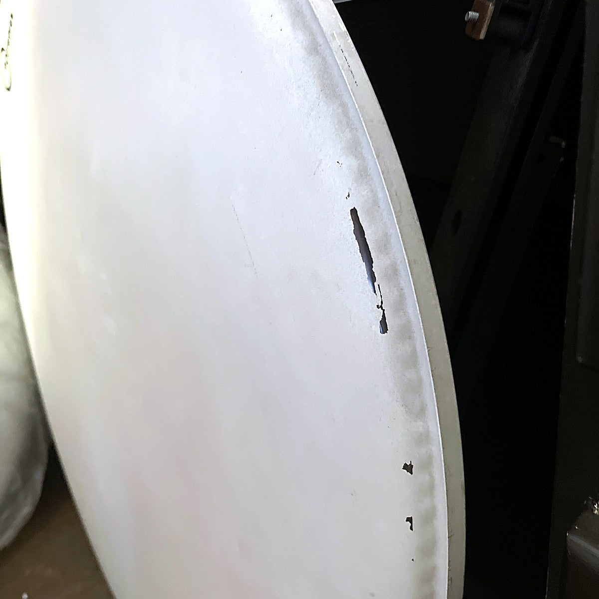 Close-up of coating chips near the edge of the Aquarian 24 inch bass drum head